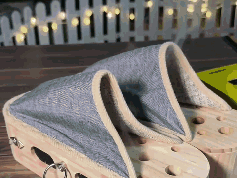 warm smoke rising gently through the holes of the wooden soles at dusk